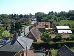 Looking South along The Street with the Church in the trees in the distance on the right.