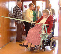 Jean cuts the ceremonial ribbon